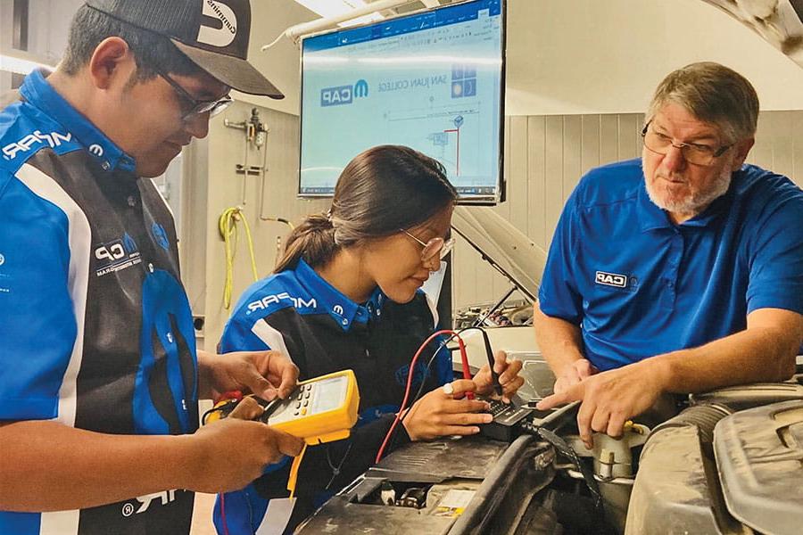 Students hands on in the Mopar Career Automotive Program